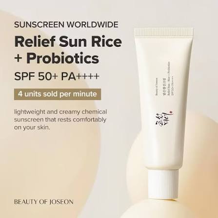 Sunscreen tube with text about SPF 50+ PA++++ and probiotics on a light background