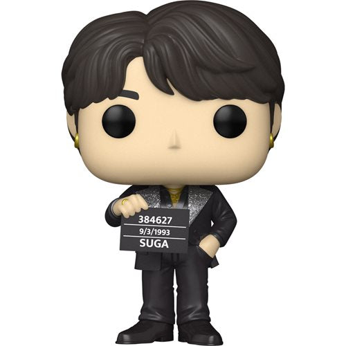 Funko Pop! Vinyl figure of BTS SUGA from the “Butter” music video, wearing a black suit with silver glitter accents, holding a placard with his name and birthdate, styled with parted dark hair and gold earrings.