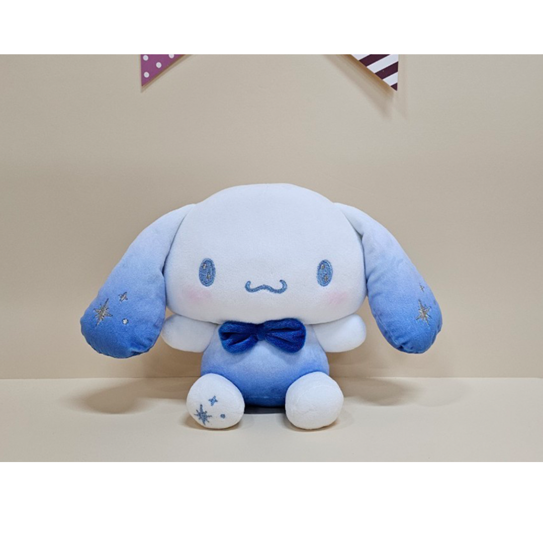 Soft Cinnamoroll plush in a blue ombré outfit with embroidered stars and a satin bowtie, perfect for collectors and fans of Sanrio characters.