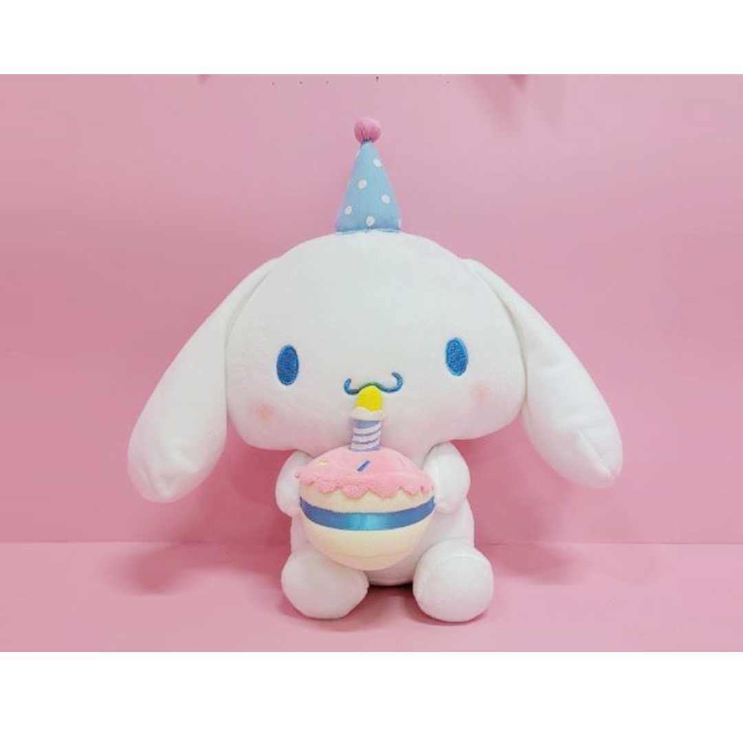 Cinnamoroll birthday edition plush holding a pastel cake with candle and wearing a blue party hat.