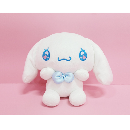 "Cinnamoroll Sanrio plush toy with blushing cheeks, blue bow, and shy pose – soft white stuffed animal for kawaii collectors and sweet gift ideas"