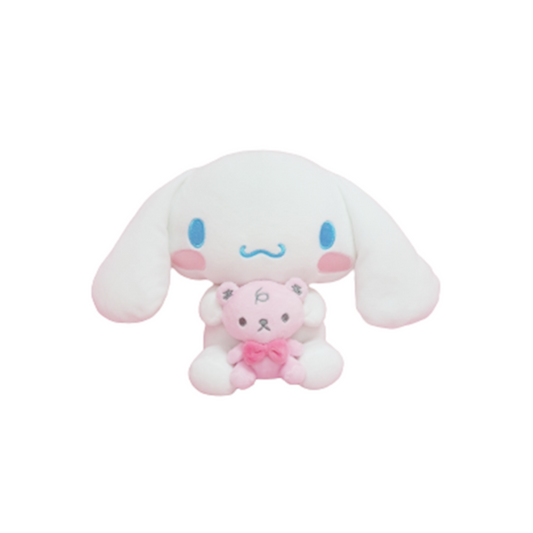 Cinnamoroll plush toy holding a pink teddy bear with bow, featuring blue eyes, floppy ears, and blushing cheeks — cute Sanrio collectible gift for kawaii lovers and plush toy fans.