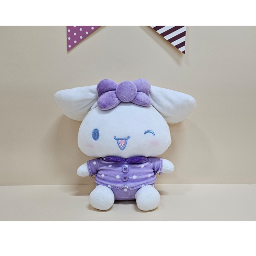 Adorable Cinnamoroll plush with a playful wink, purple bow and outfit with polka dots, ideal for kawaii lovers.
