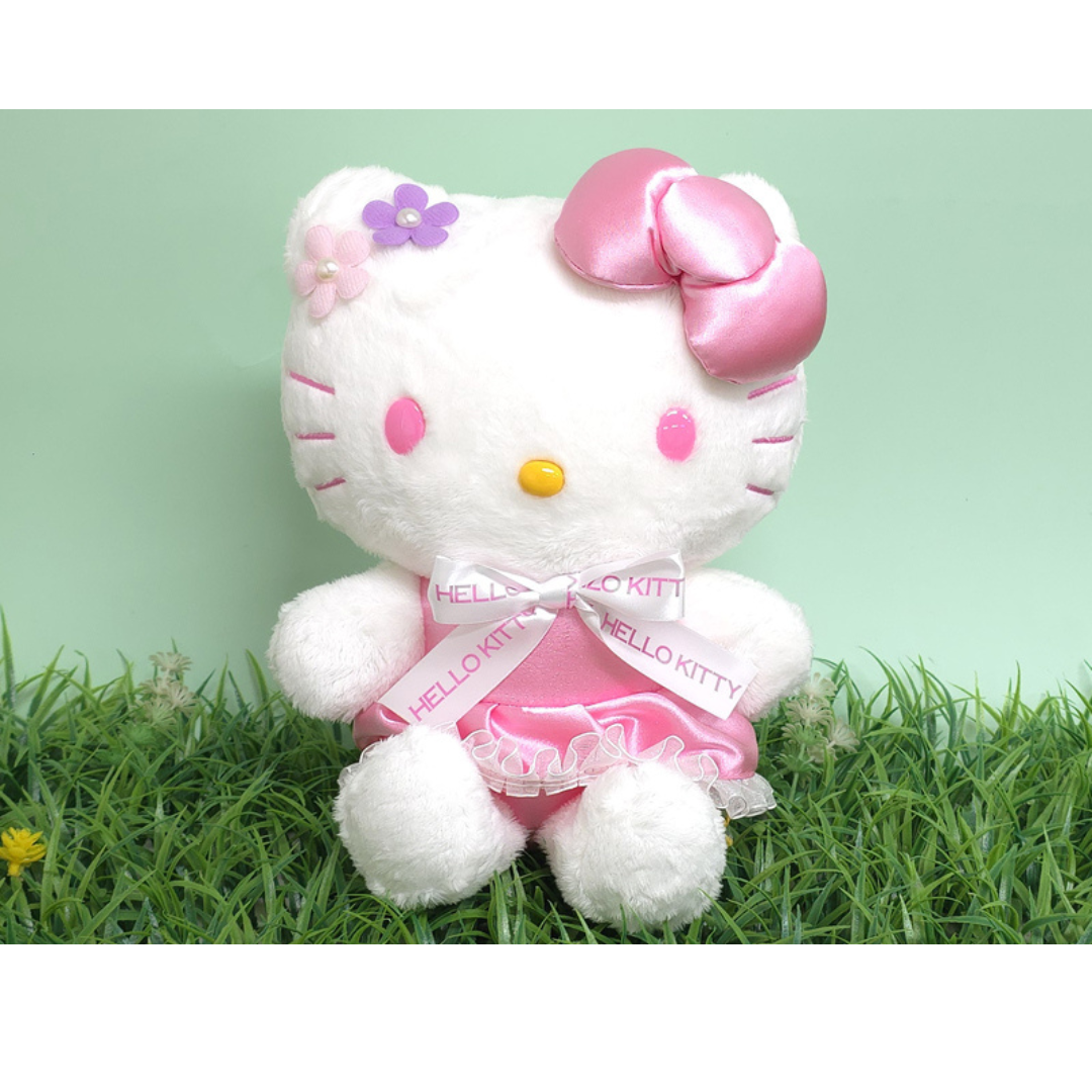 “Hello Kitty plush in pink floral ribbon dress – featuring soft white fur, flower appliqués and pink satin bow, great for springtime gifting.”
