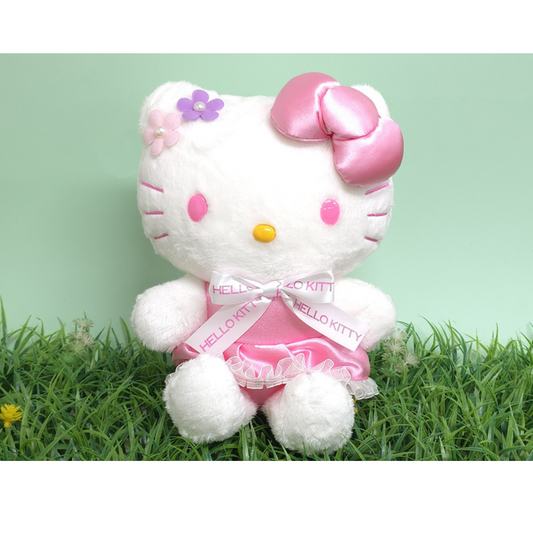 “Hello Kitty plush in pink floral ribbon dress – featuring soft white fur, flower appliqués and pink satin bow, great for springtime gifting.”
