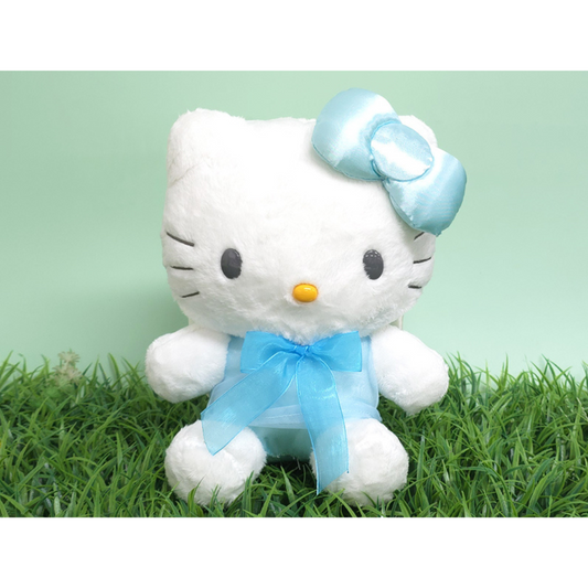 “Hello Kitty plush in sky blue outfit and satin bow – set on grass background, soft white fur toy perfect for gifting or room decor.”