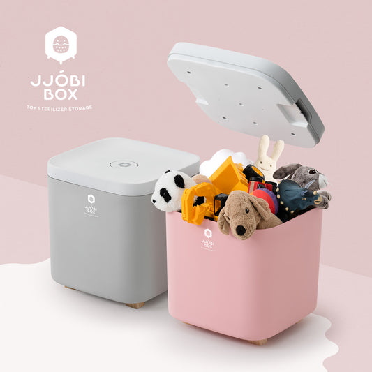 JJOBI Box toy sterilizer and storage in pink and gray – UV-C light sterilization bin filled with plush toys and kids' items, modern design.