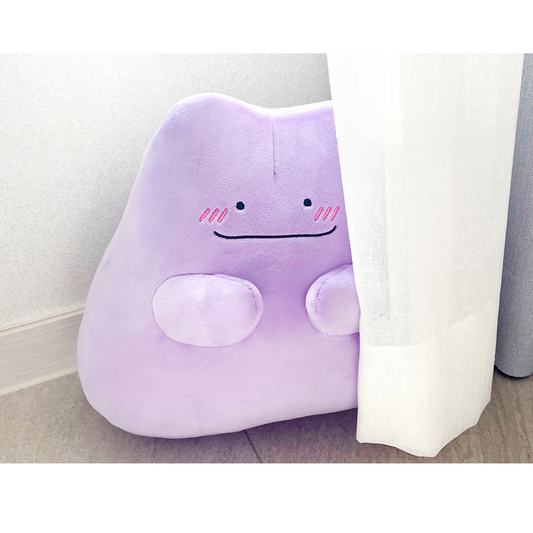 Pokémon Ditto plush in light purple, peeking shyly from behind a curtain with blushing cheeks.