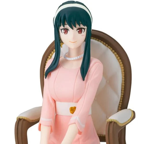 Spy x Family Yor Forger anime statue figure seated in a chair wearing pink dress, from family photo scene.